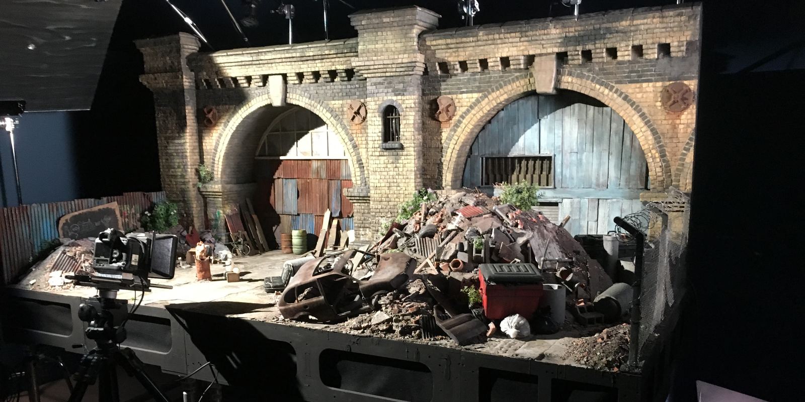 A detailed miniature stop-motion film set from an Aardman production, with a camera and lights
