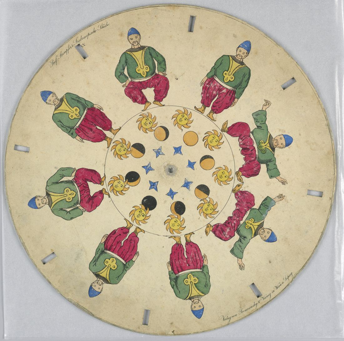 A hand-coloured phenakistiscope disc with dancing figures and slits around the edge