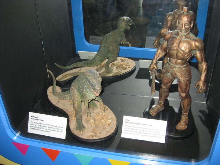 Stop-motion models of an allosaurus and a bronze giant made by Ray Harryhausen, on display in a museum