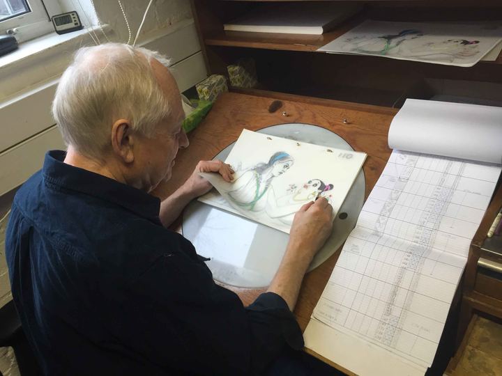 Animator Richard Williams drawing at a desk at Aardman Animations in 2015